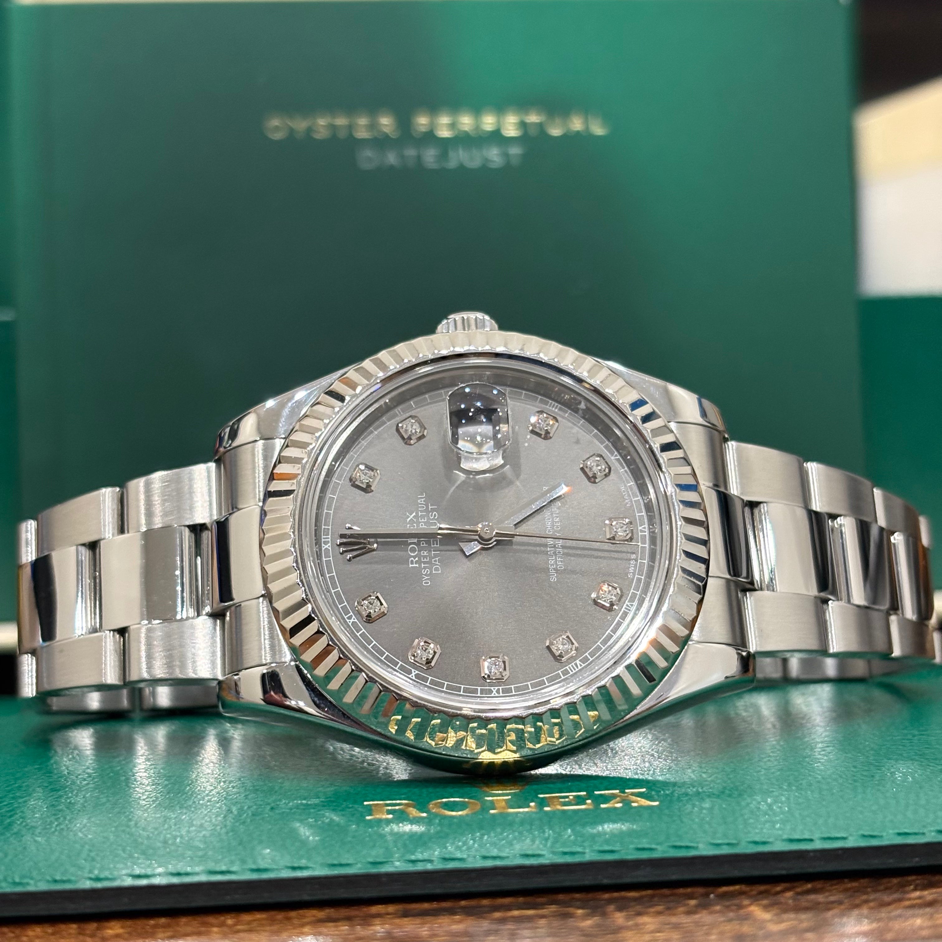Rolex Datejust 41 slate diamond dial side on view in front of the Datejust booklet