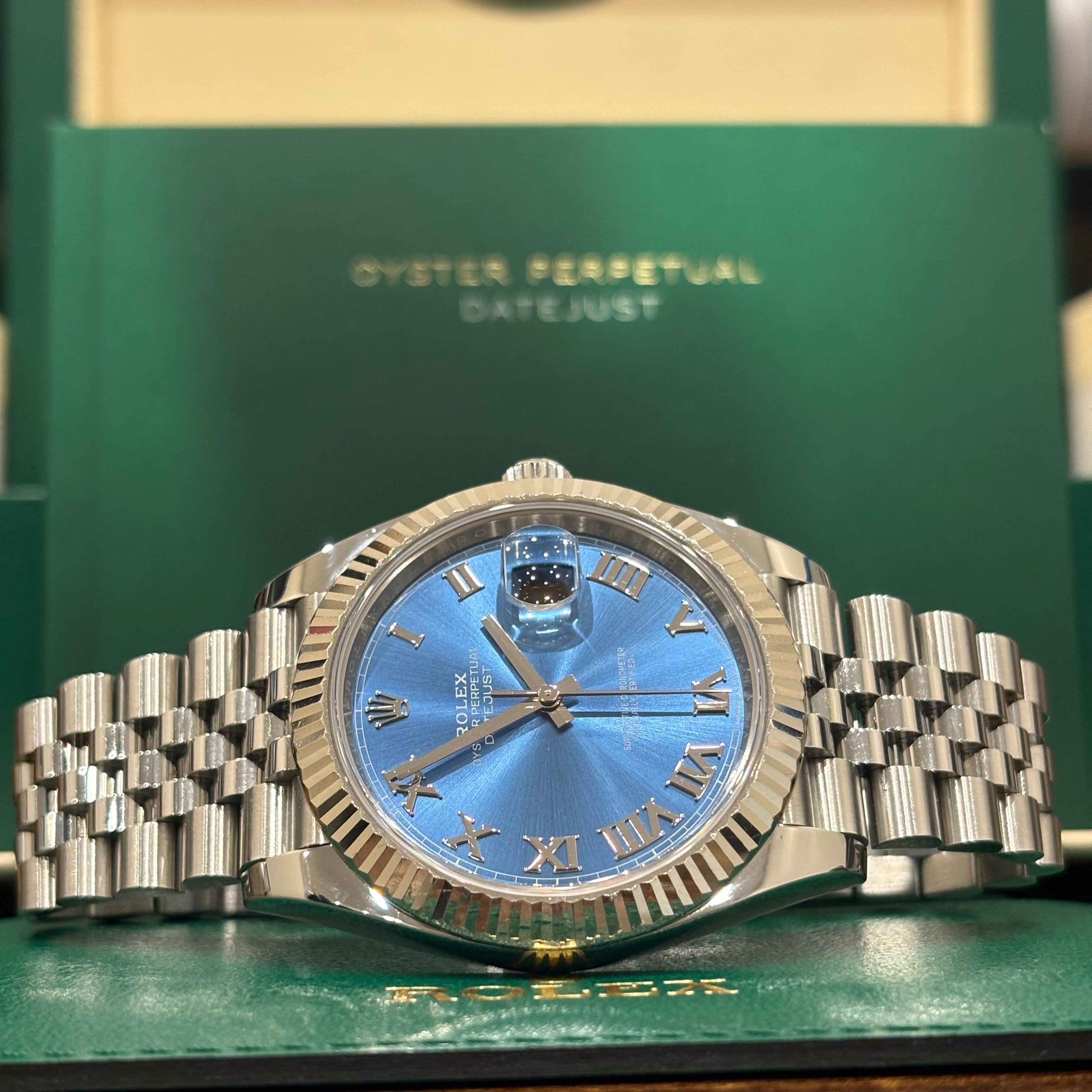 Rolex Datejust 41 Azzurro blue Roman dial laid on its green Rolex wallet
