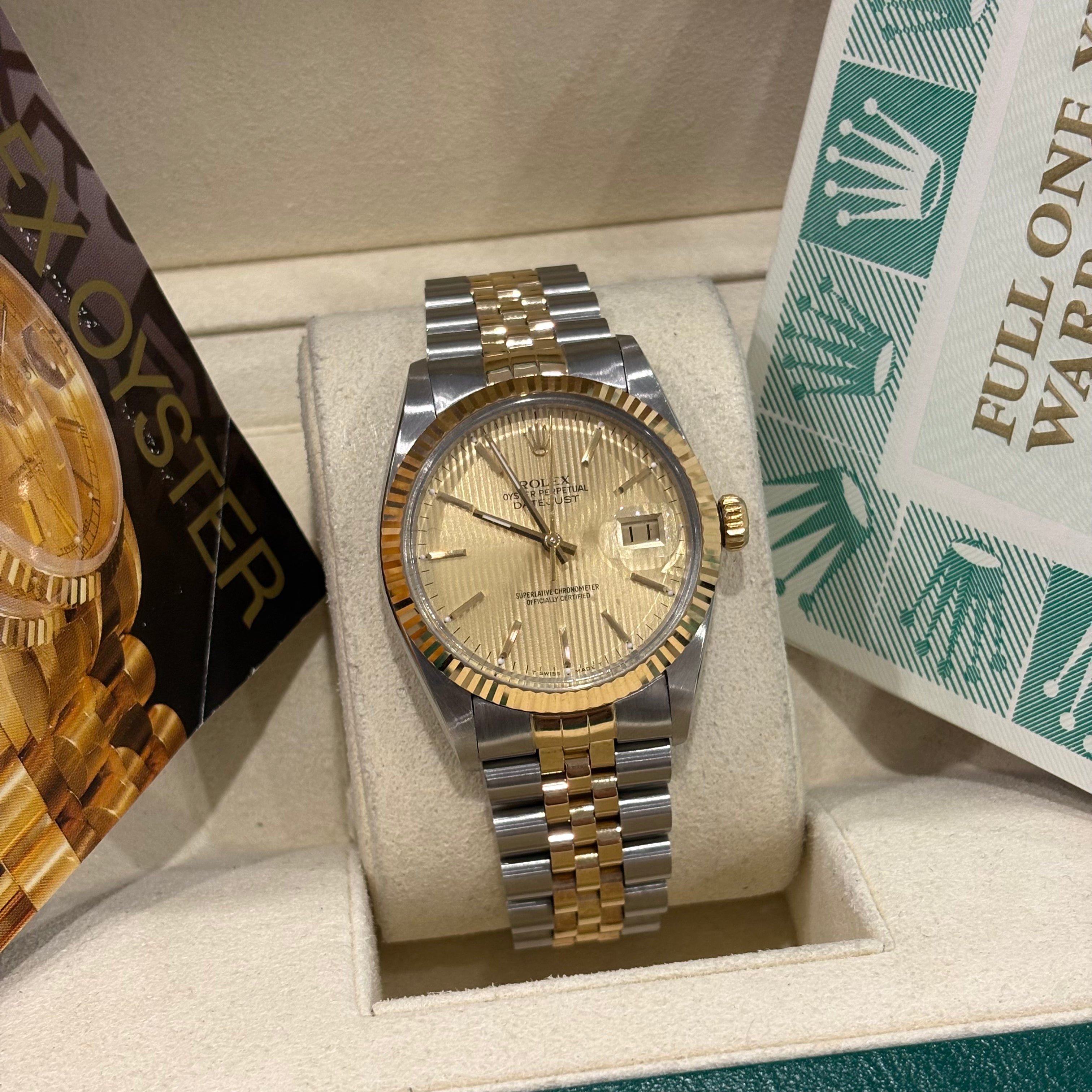 Rolex Datejust 36 champagne tapestry dial angled view of the fluted yellow gold bezel and crown