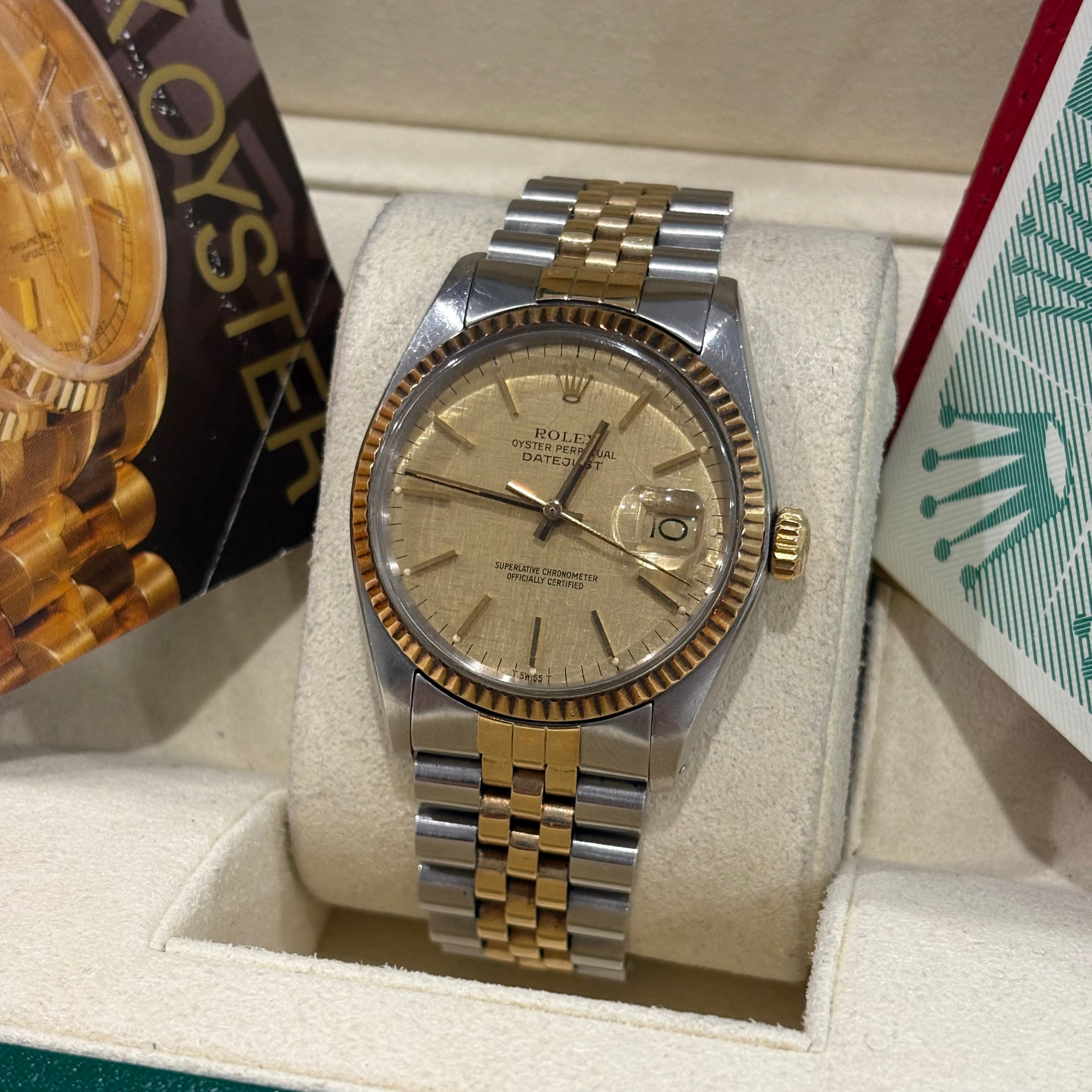 Rolex Datejust 36 champagne linen dial angled view showing the yellow gold crown and fluted bezel