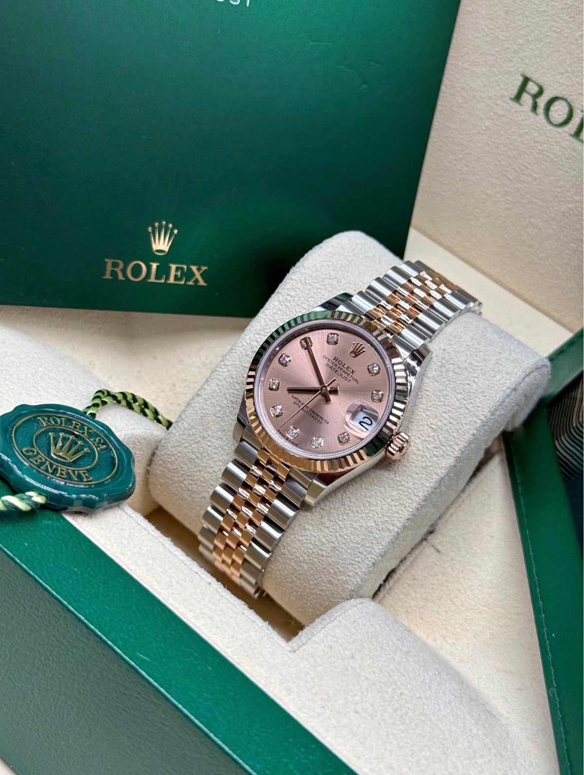 Rolex Datejust 31mm Sundust dial angled view showing the factory diamond hour markers and Everose gold fluted bezel