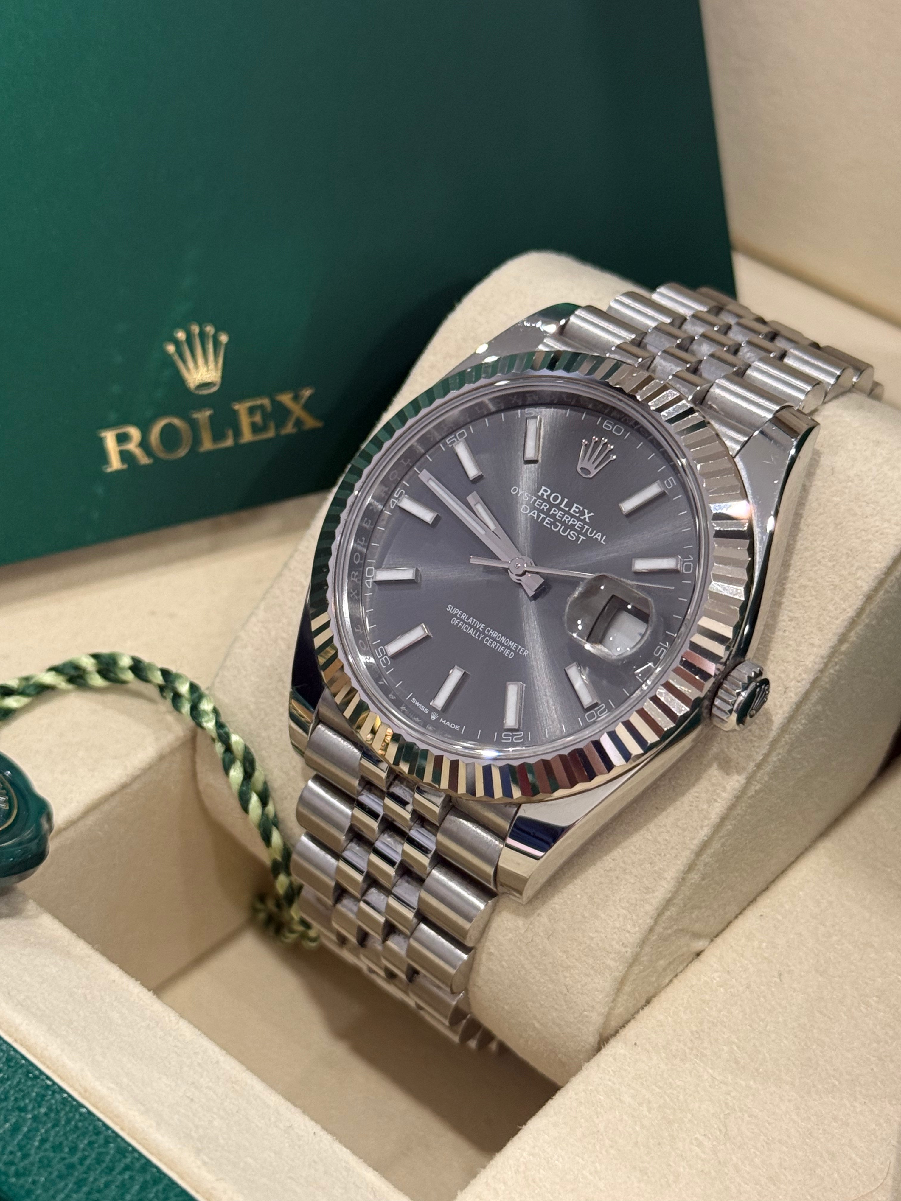 Rolex Datejust 41mm slate dial angled view on its cushion showing the winding crown