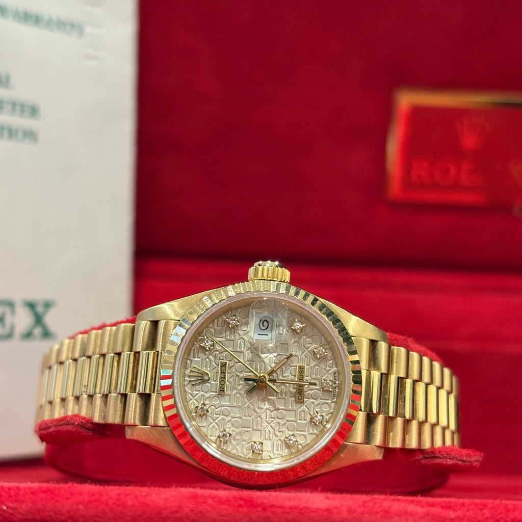 Rolex Lady Datejust 26mm yellow gold diamond dial side on view of the fluted bezel and President bracelet