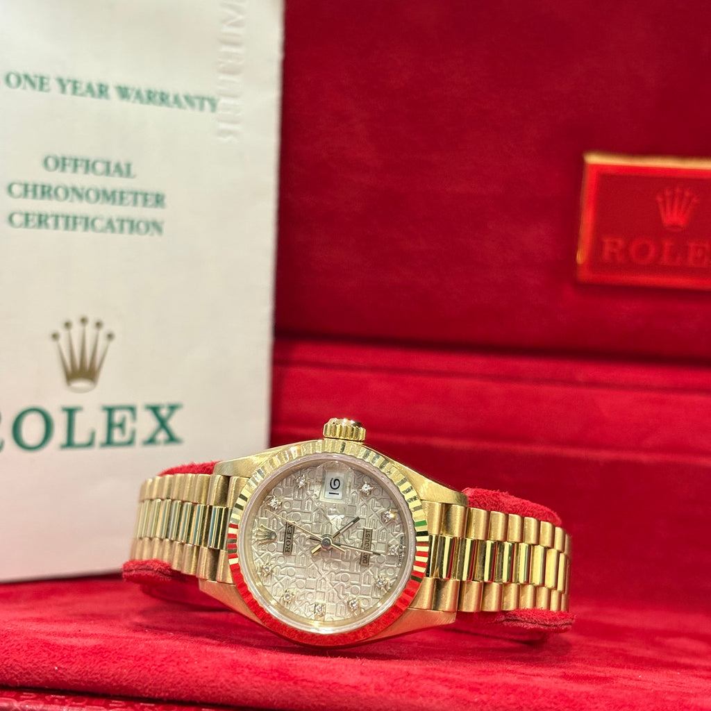 Rolex Lady Datejust 26mm 18K yellow gold diamond dial wide view in front of its vintage red Rolex box